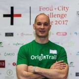 Portrait photo of Branimir Rakic wearing a green OriginTrail t-shirt