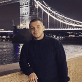 Portrait photo of Milan Djordjevic posing next to the London bridge and river